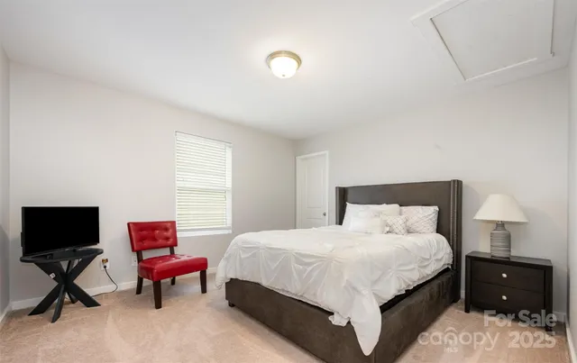 a bedroom with a bed and a chair