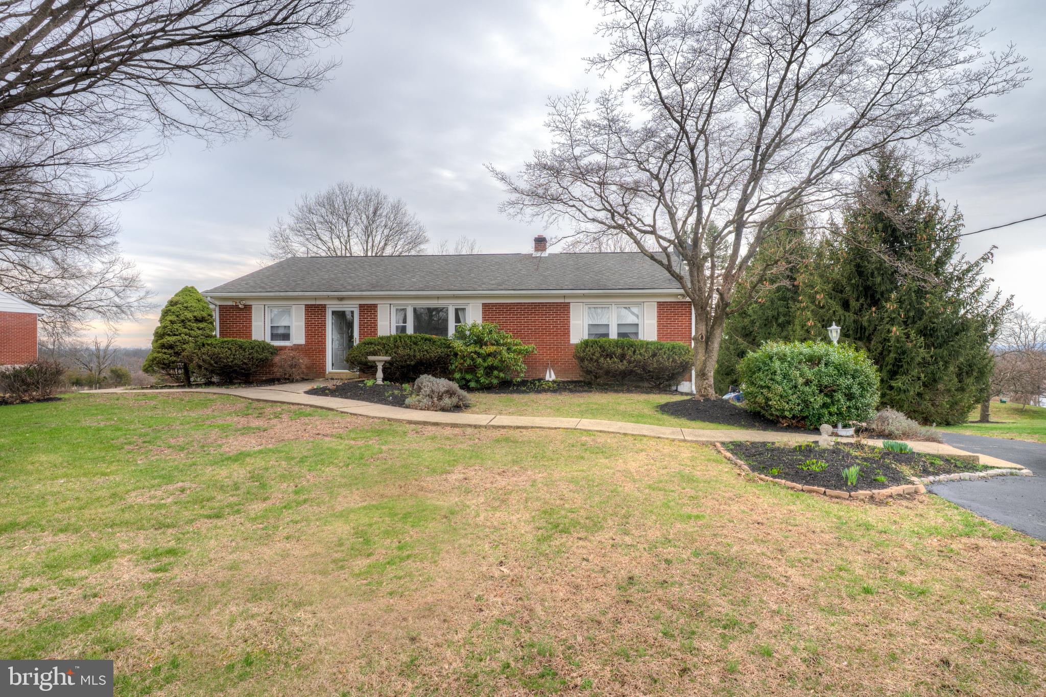 a front view of house with yard and green space