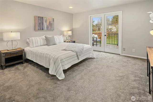 a spacious bedroom with a bed and a night stand