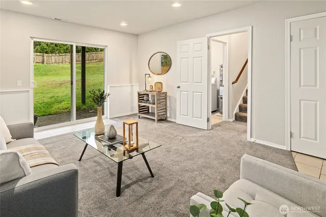 a living room with furniture and a floor to ceiling window