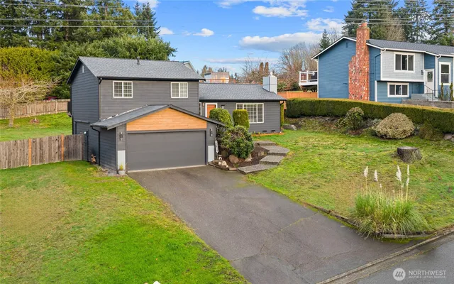 a front view of house with yard and outdoor seating