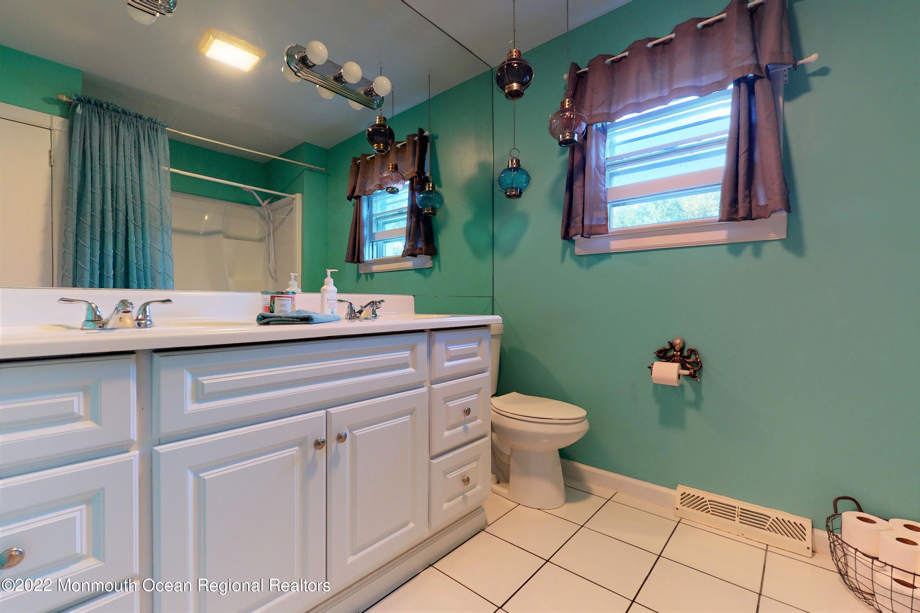 919 Monmouth Road Cream Ridge, NJ 08514 - Photo 12 of 27 a bathroom with a toilet sink and mirror