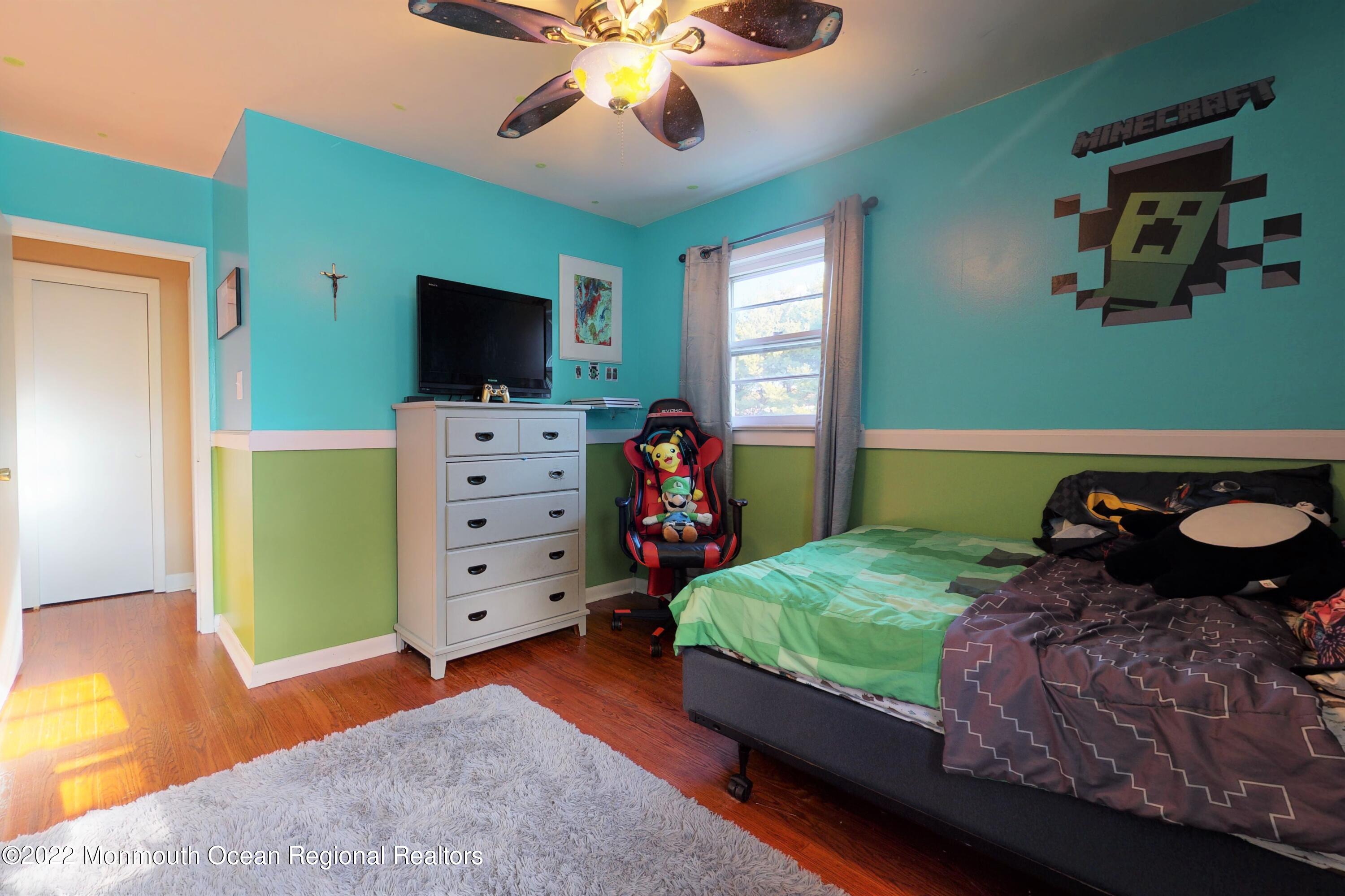 919 Monmouth Road Cream Ridge, NJ 08514 - Photo 19 of 27 a bed room with a bed and a television