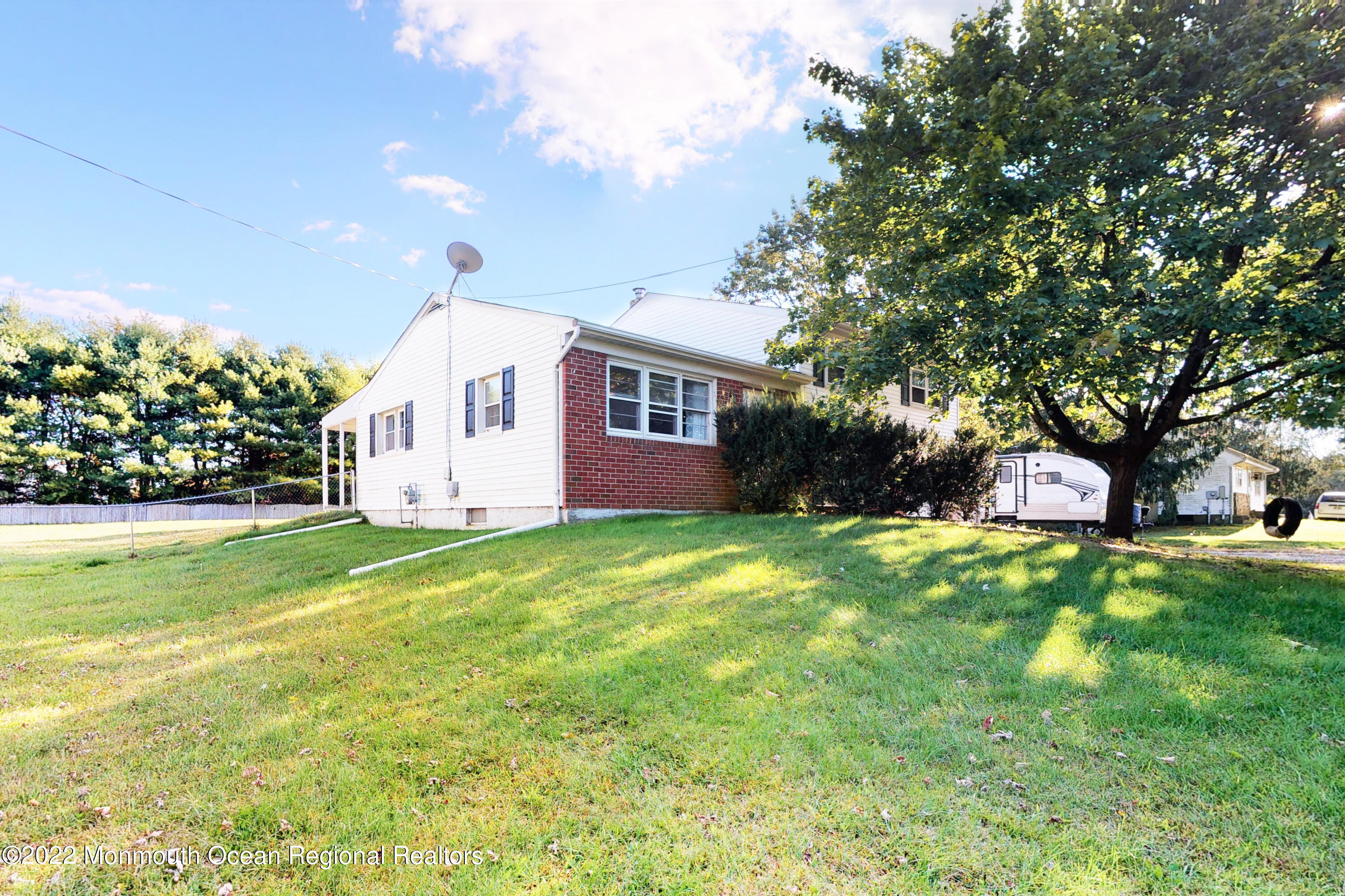 919 Monmouth Road Cream Ridge, NJ 08514 - Photo 26 of 27 a front view of house with yard and trees