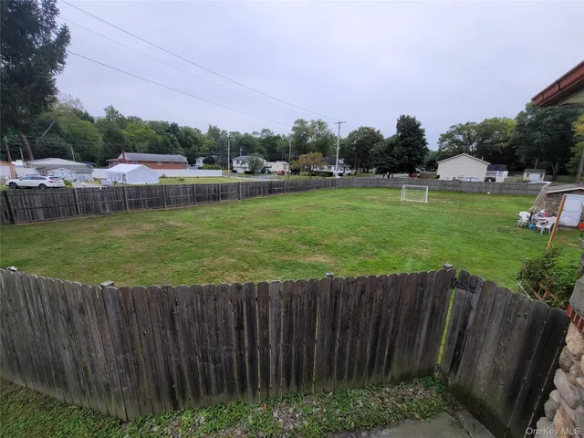 a view of a garden with wooden fence