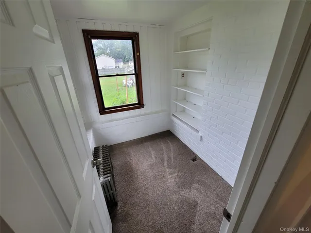 a view of hallway with window and entryway