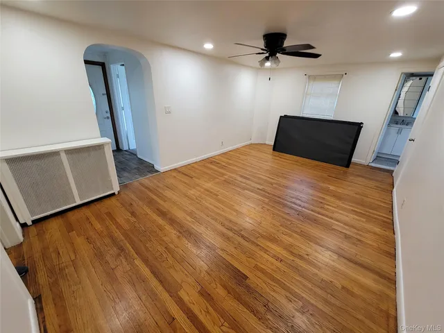 wooden floor in an empty room with a window