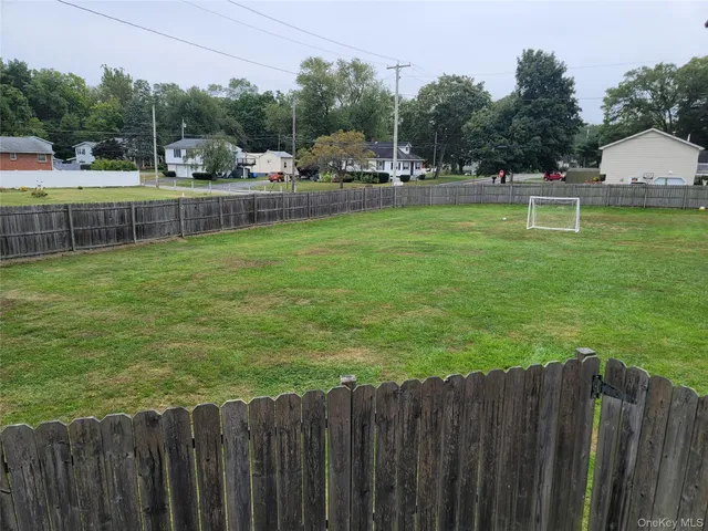 a view of a backyard with a garden and deck
