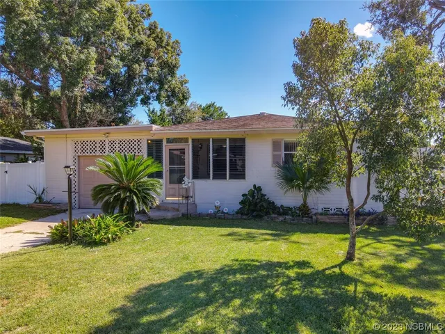 a house view with swimming pool in front of it