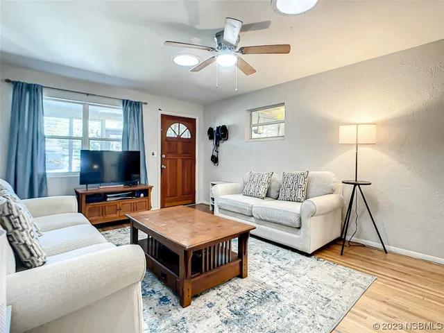 a living room with furniture and a flat screen tv