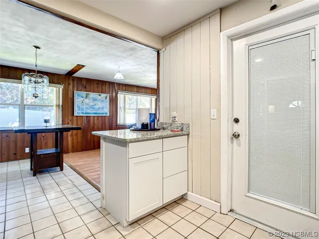 a kitchen with stainless steel appliances kitchen island granite countertop a refrigerator and a stove