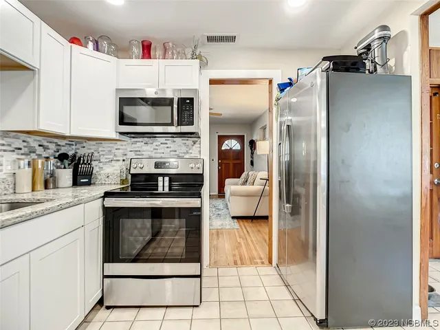 a kitchen with cabinets and stainless steel appliances
