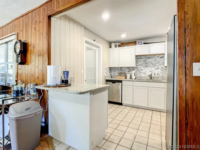 a kitchen with a sink a stove and cabinets