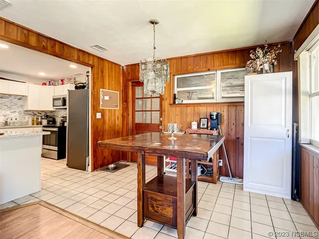 a kitchen with stainless steel appliances kitchen island granite countertop a refrigerator and a stove top oven