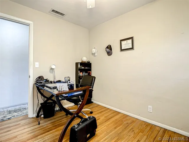 a work room with furniture and wooden floor