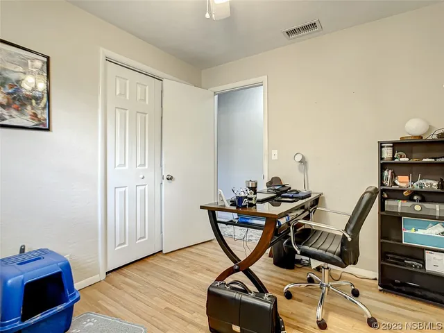 a view of a workspace with furniture and wooden floor