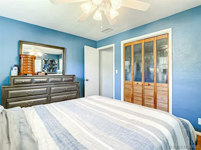 a bedroom with a large bed and a large window