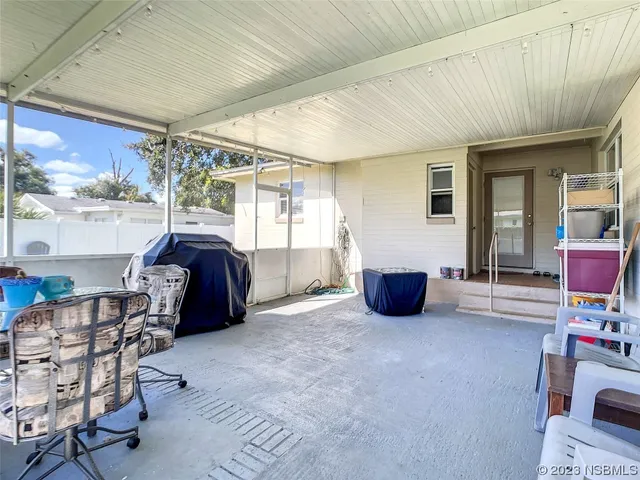 a living room with furniture a flat screen tv and a large window