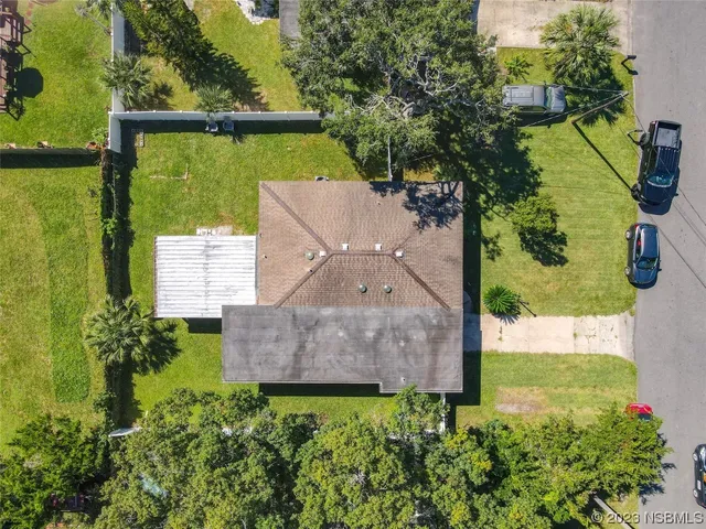an aerial view of residential houses with outdoor space and a lake view