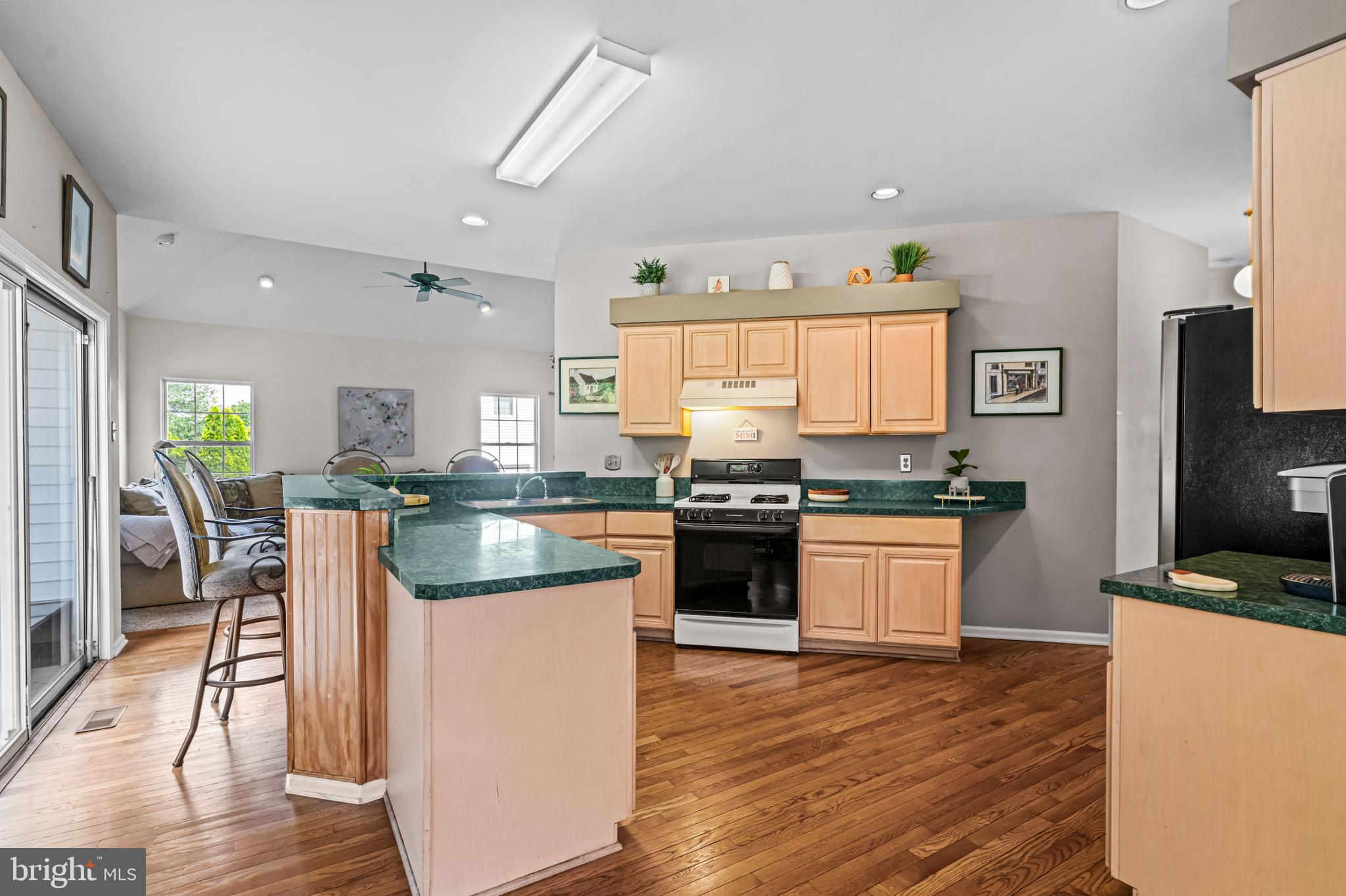1720 Hampton Drive Jamison, PA 18929 - Photo 5 of 41 a kitchen with kitchen island granite countertop wooden floors and stainless steel appliances
