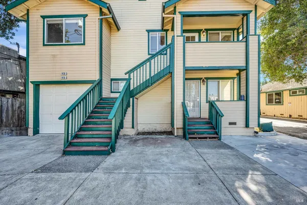 a view of front door of house with stairs