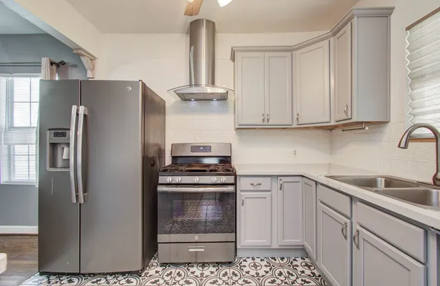 a kitchen with a refrigerator sink and cabinets