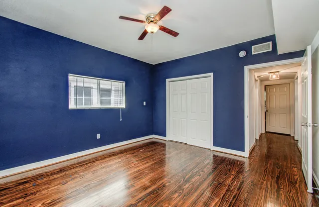 a view of room with window and wooden floor