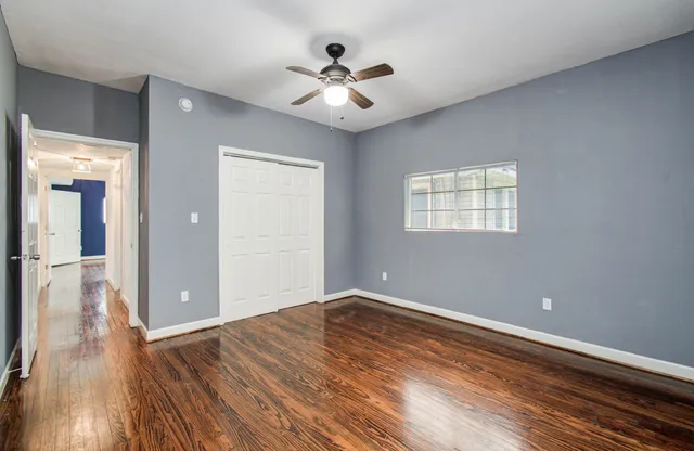 wooden floor in an empty room with a window