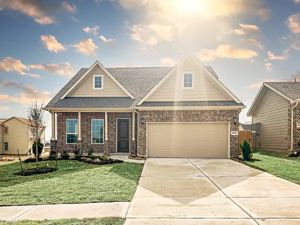 a front view of a house with a yard and potted plants