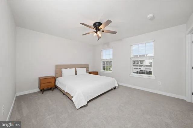 a spacious bedroom with a bed and window