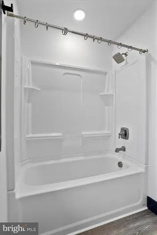 a bathroom with a shower and a bath tub