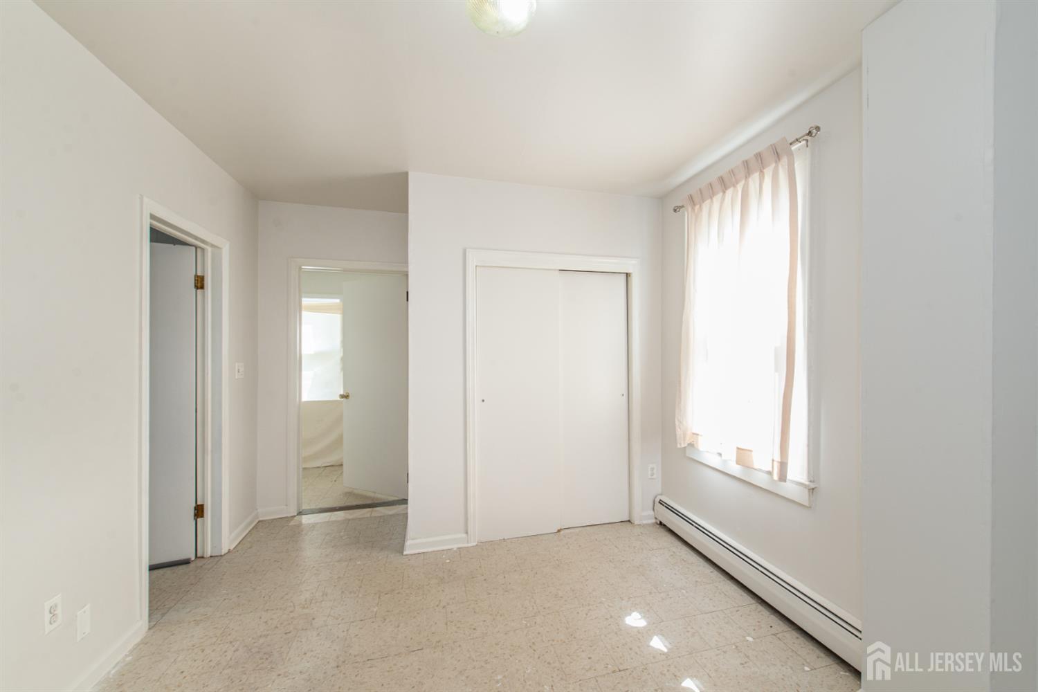 4 Lefferts Street Carteret, NJ 07008 - Photo 18 of 32 an empty room with windows and closet