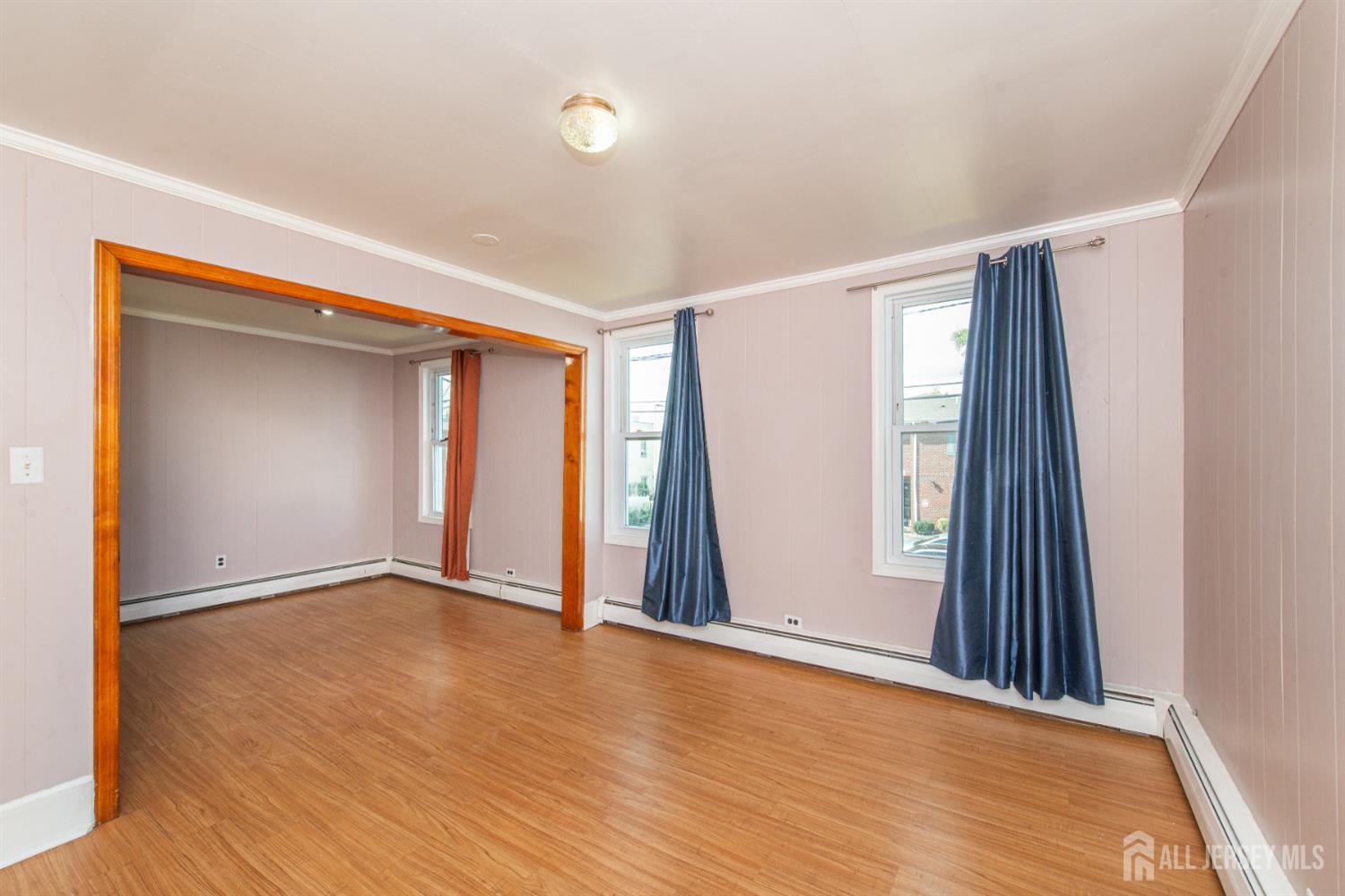 4 Lefferts Street Carteret, NJ 07008 - Photo 20 of 32 a view of an empty room with wooden floor and a window