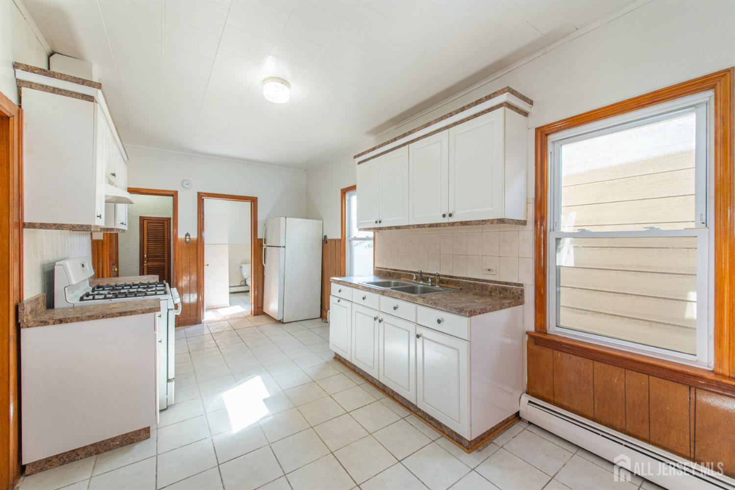 4 Lefferts Street Carteret, NJ 07008 - Photo 24 of 32 a kitchen with stainless steel appliances granite countertop a stove and a refrigerator