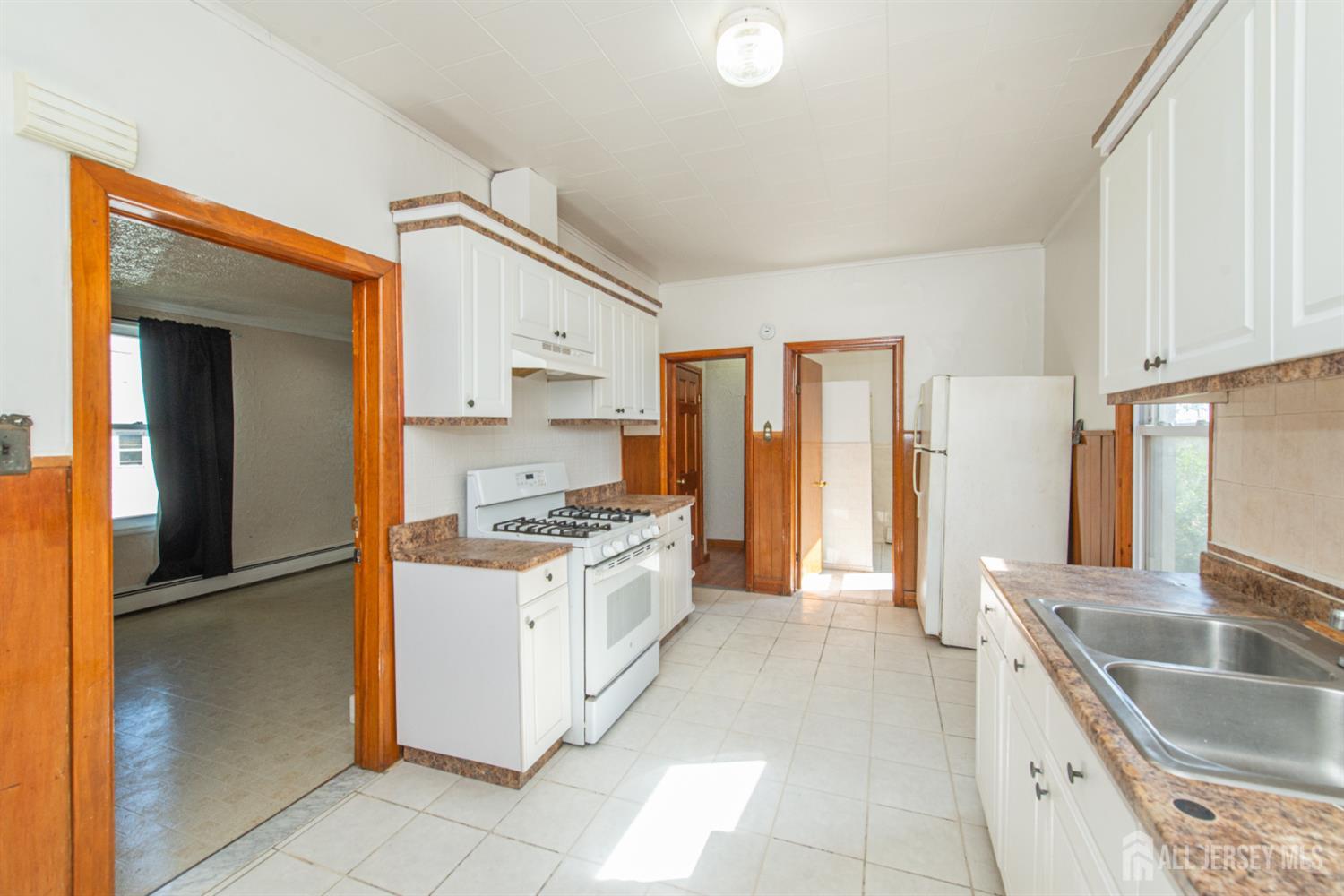 4 Lefferts Street Carteret, NJ 07008 - Photo 25 of 32 a kitchen with granite countertop a sink stove and refrigerator