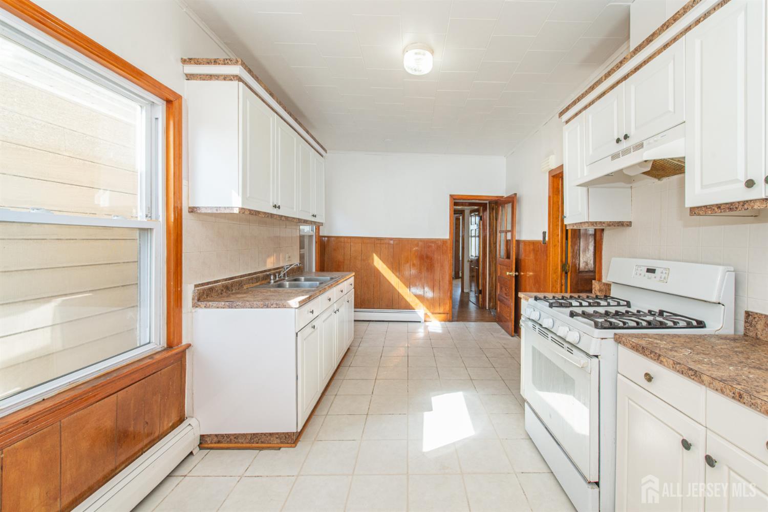 4 Lefferts Street Carteret, NJ 07008 - Photo 26 of 32 a kitchen with stainless steel appliances granite countertop a stove and a refrigerator