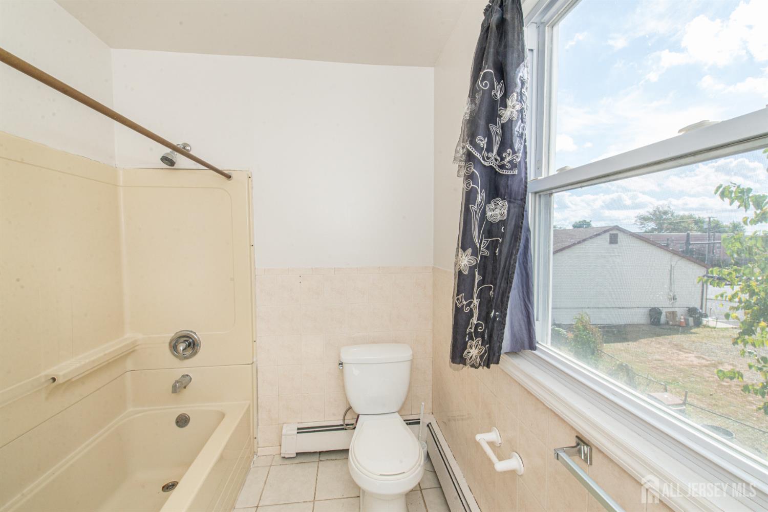 4 Lefferts Street Carteret, NJ 07008 - Photo 28 of 32 a bathroom with a toilet and a shower