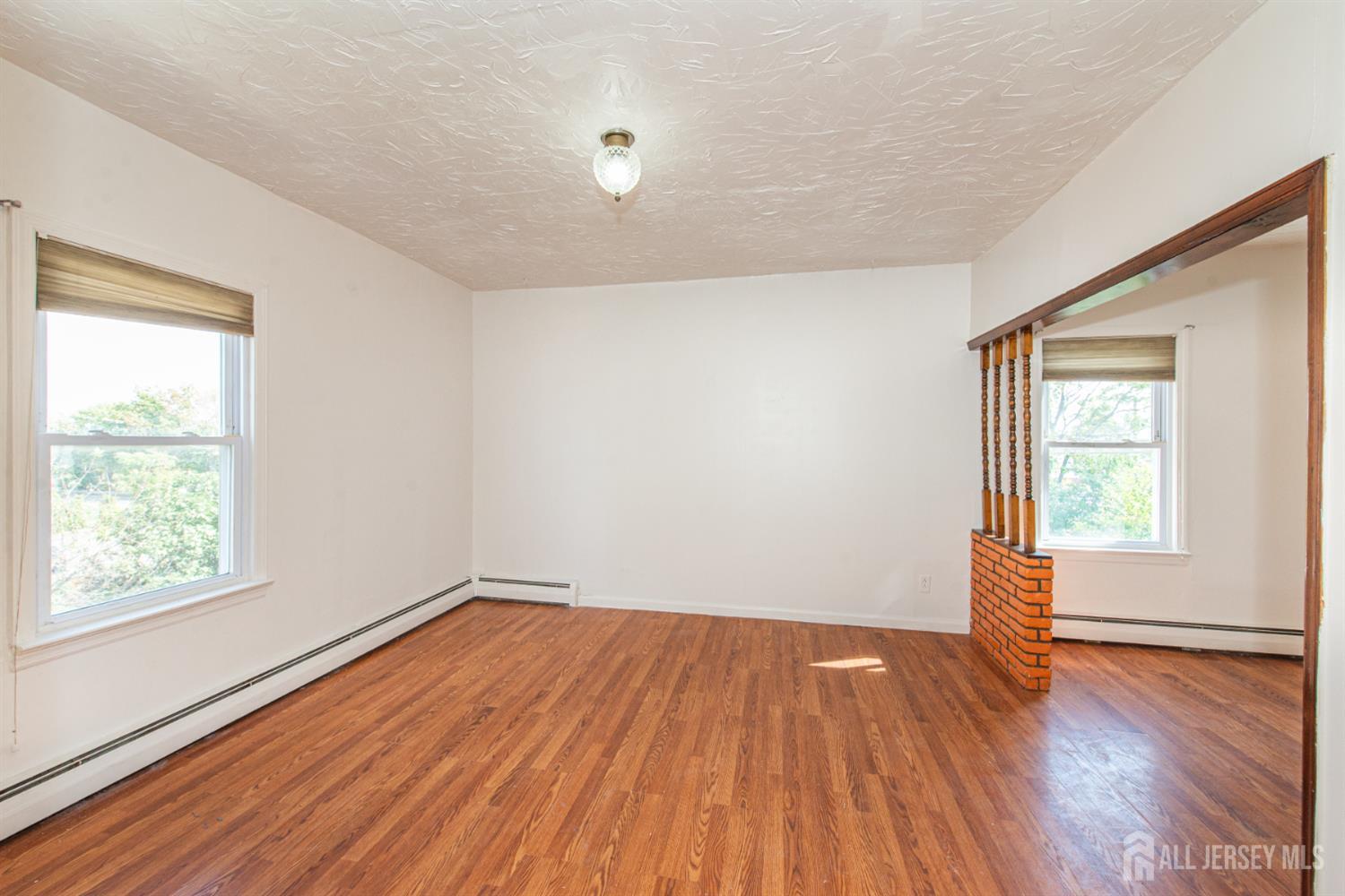 4 Lefferts Street Carteret, NJ 07008 - Photo 29 of 32 an empty room with wooden floor and windows
