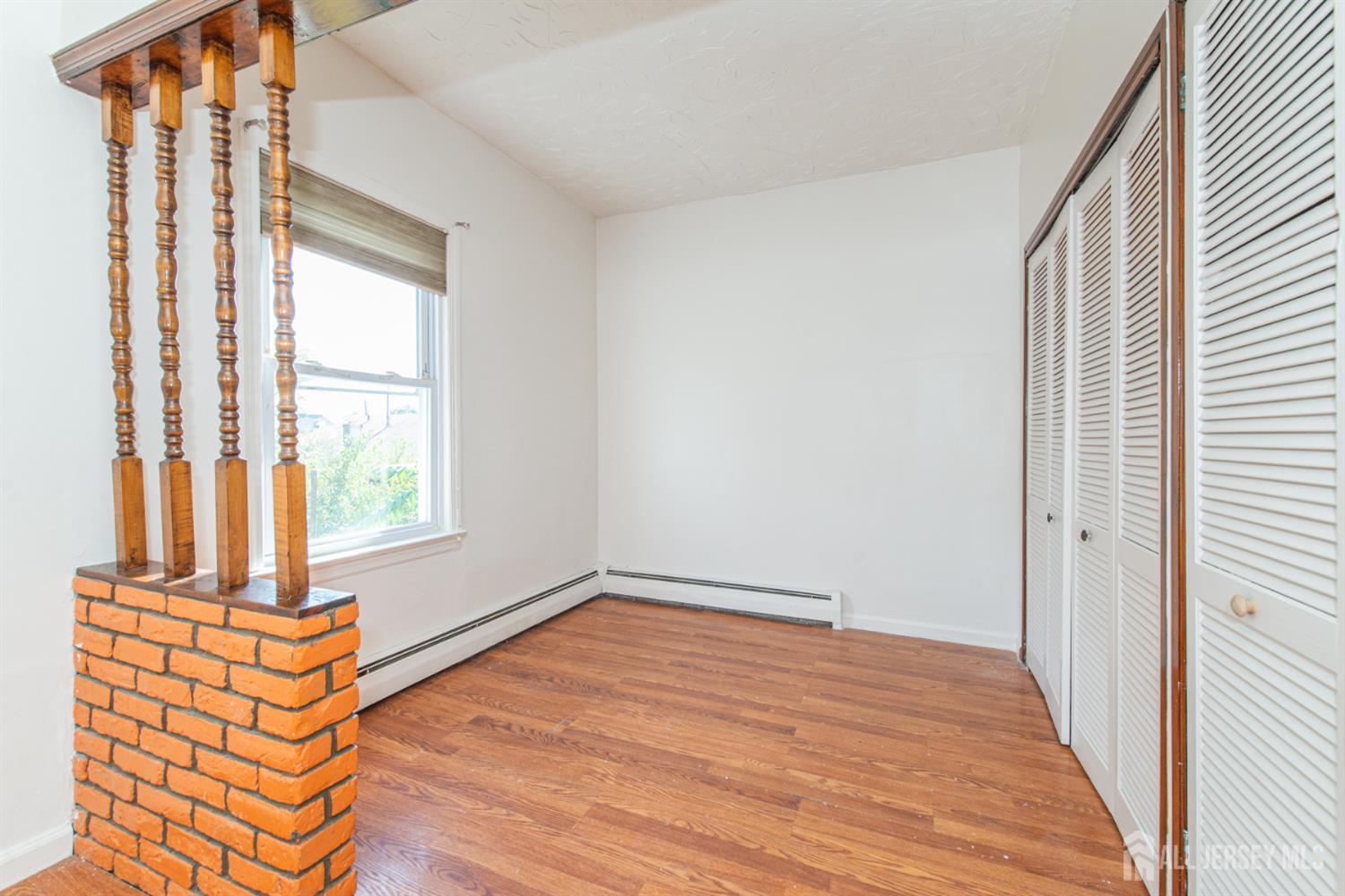 4 Lefferts Street Carteret, NJ 07008 - Photo 30 of 32 a view of an empty room with wooden floor and a window