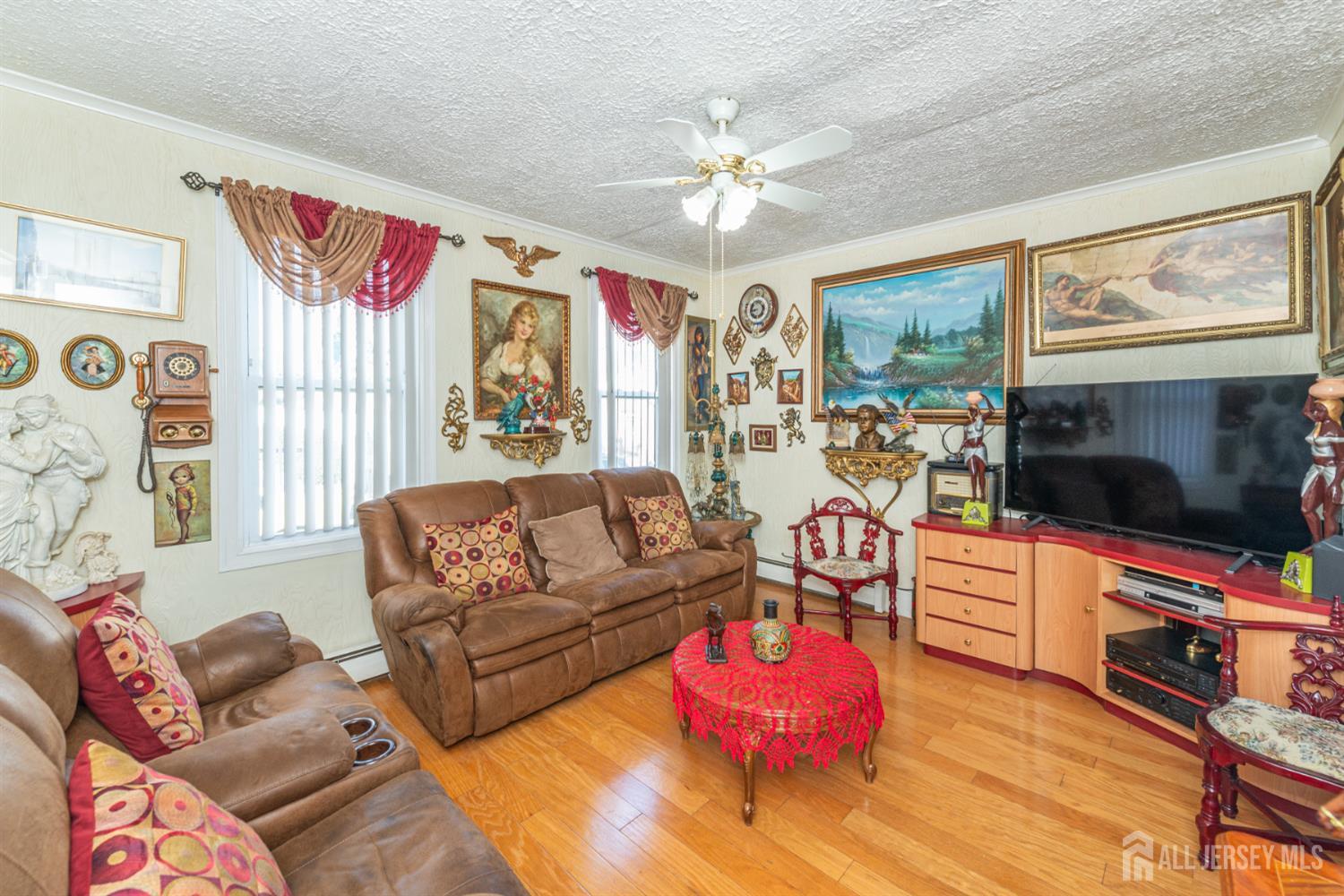 4 Lefferts Street Carteret, NJ 07008 - Photo 6 of 32 a living room with furniture a flat screen tv and a fireplace