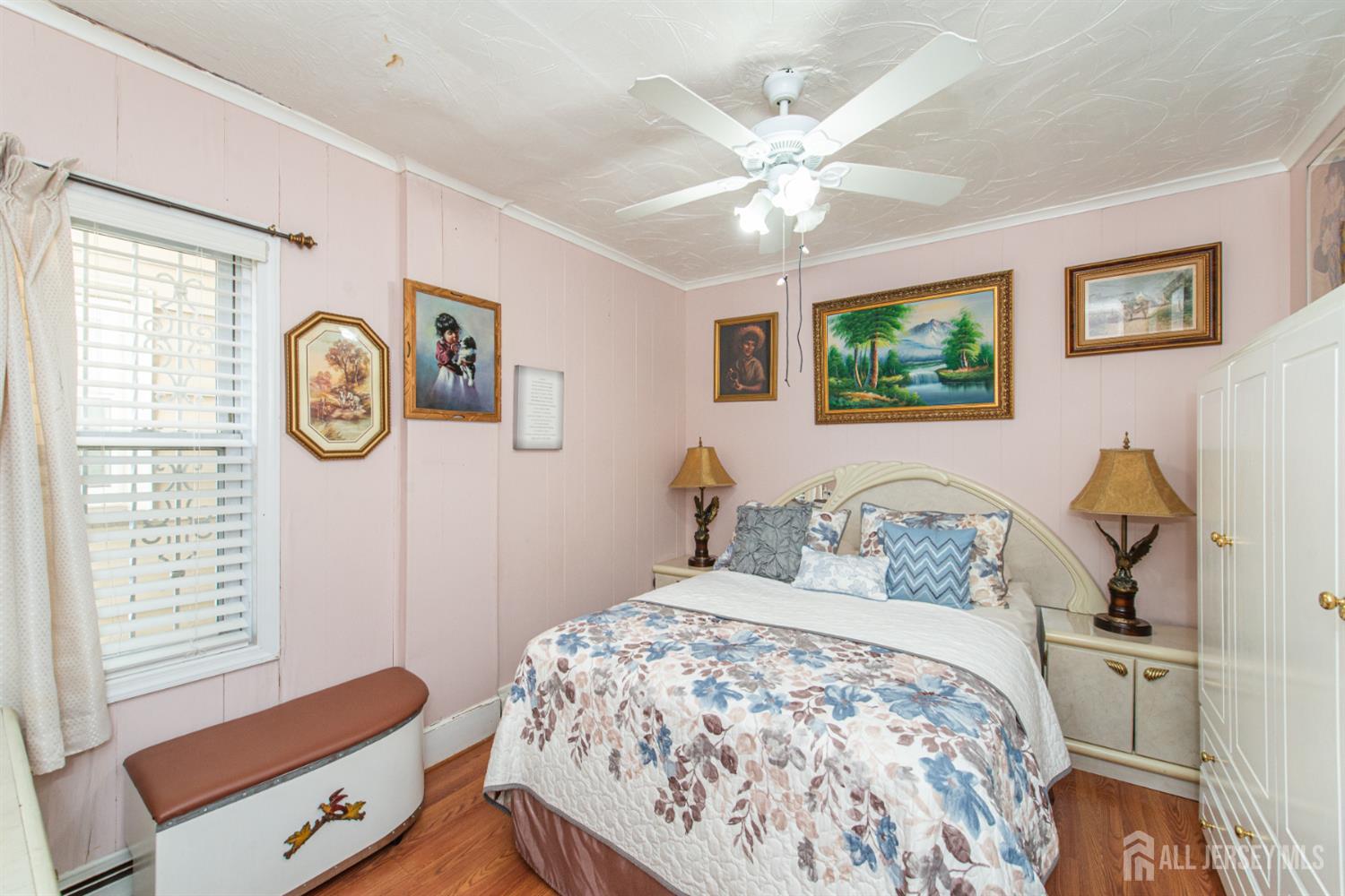 4 Lefferts Street Carteret, NJ 07008 - Photo 10 of 32 a bedroom with a large bed and a chandelier