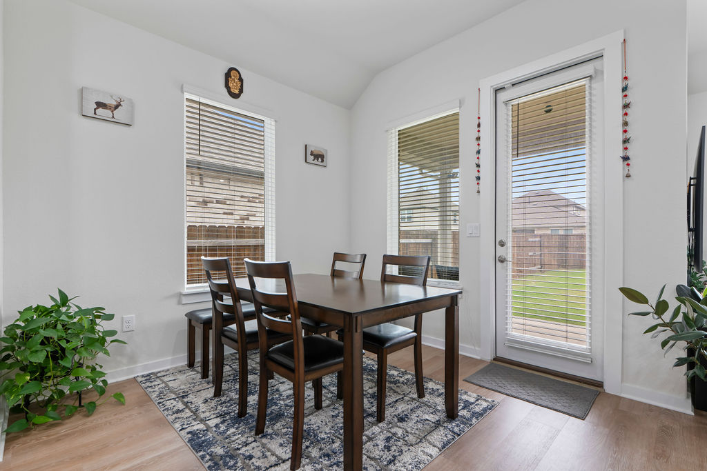 1813 Crow Hop View Leander, TX 78641 - Photo 12 of 33 a view of a dining room with furniture and wooden floor