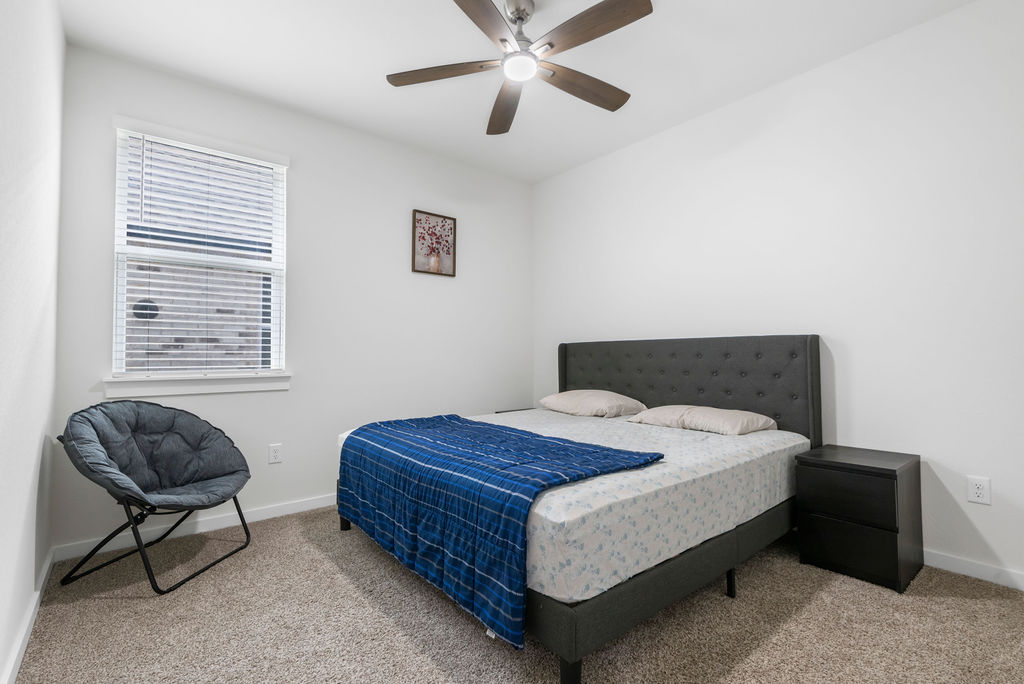 1813 Crow Hop View Leander, TX 78641 - Photo 23 of 33 a bedroom with a bed and window