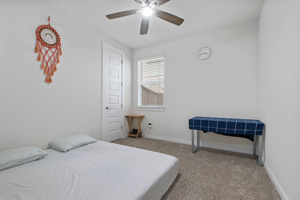 1813 Crow Hop View Leander, TX 78641 - Photo 24 of 33 a bedroom with a bed and a chandelier