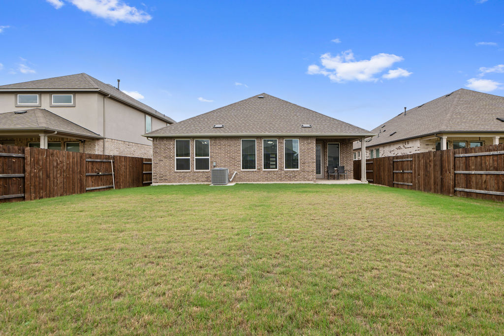 1813 Crow Hop View Leander, TX 78641 - Photo 31 of 33 a front view of a house with a yard