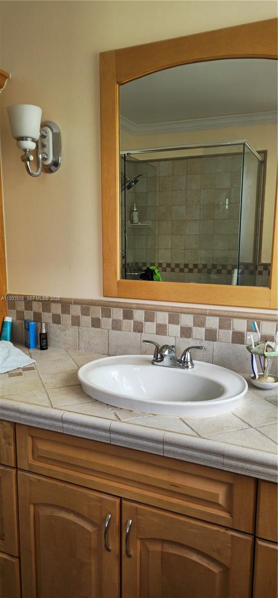 7321 Southwest 123rd Street Pinecrest, FL 33156 - Photo 4 of 7 a bathroom with a sink and a mirror
