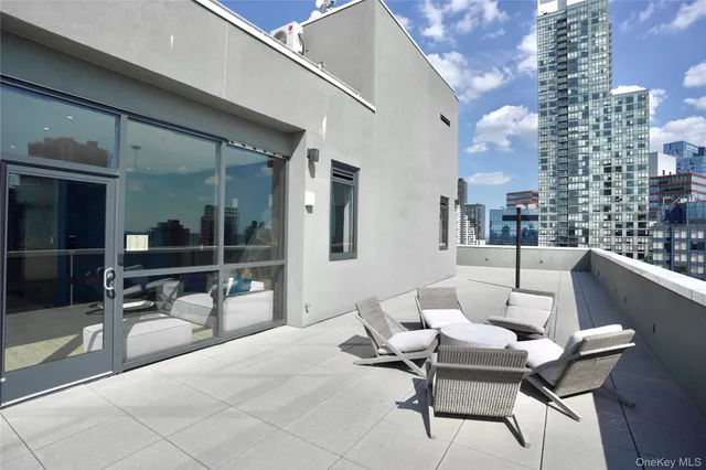 a building outdoor space with patio furniture and a potted plant