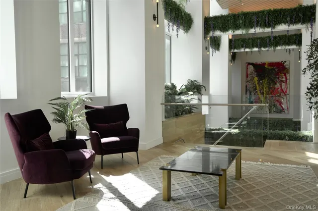 a living room with furniture and a potted plant