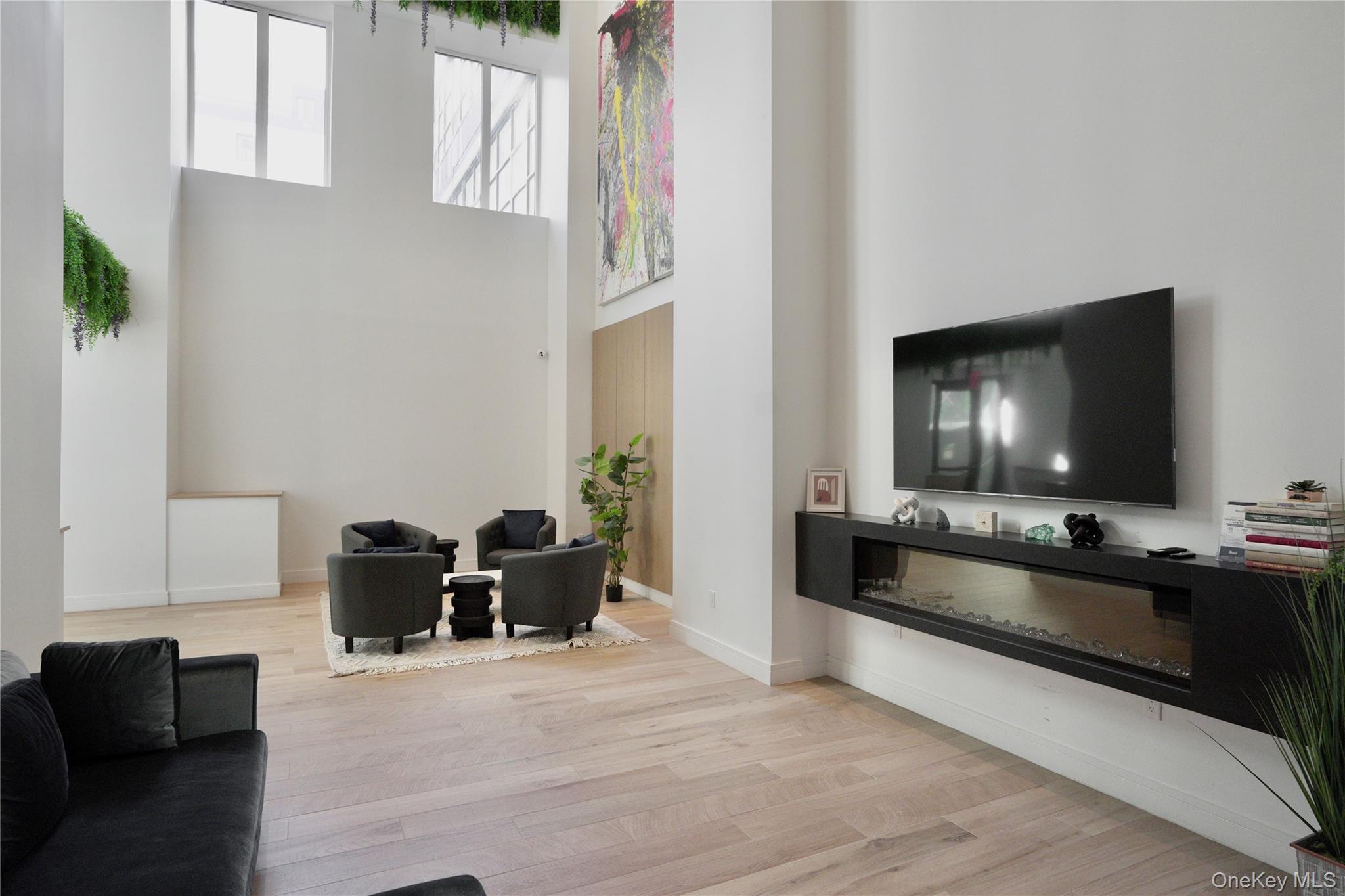 24-16 Queens Plaza South, Unit 2D Queens, NY 11101 - Photo 25 of 28 a living room with furniture and a flat screen tv