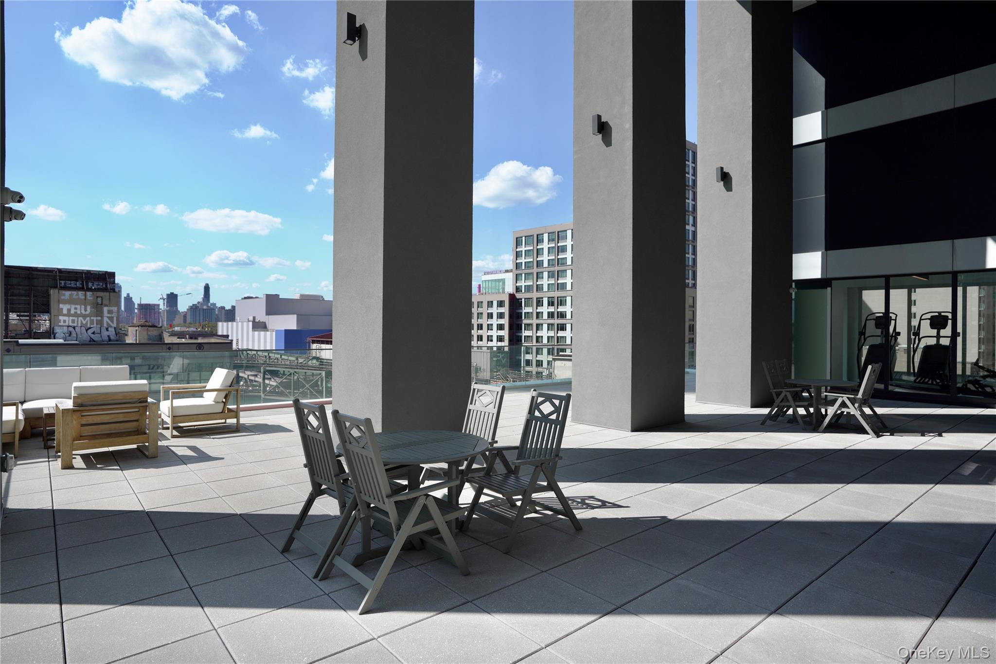 24-16 Queens Plaza South, Unit 2D Queens, NY 11101 - Photo 26 of 28 a view of a patio with dining table and chairs